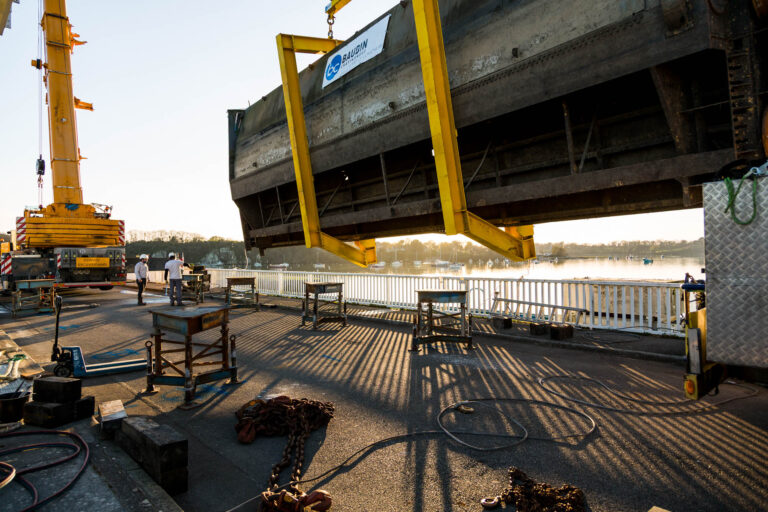 Chantier au coucher de soleil sur barrage - Vanne suspendue au-dessus de la chaussée - Photoreportage infrastructure BTP - studio photo loire-atlantique